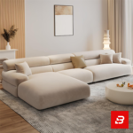 Modern minimalist luxury living room interior showcasing a spacious chaise sectional sofa upholstered in textured beige bouclé fabric featuring an extended lounge chaise and chic accent cushions by Bahoo Furniture UAE