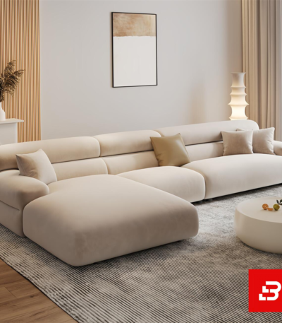 Modern minimalist luxury living room interior showcasing a spacious chaise sectional sofa upholstered in textured beige bouclé fabric featuring an extended lounge chaise and chic accent cushions by Bahoo Furniture UAE