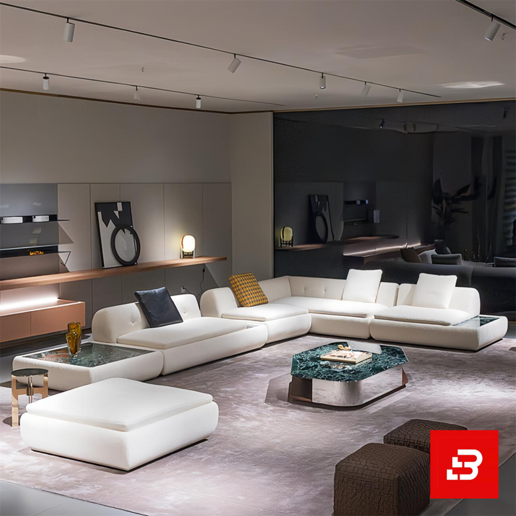 Sophisticated modern luxury showroom living room interior showcasing an expansive modular sectional sofa upholstered in textured off white bouclé fabric featuring deep tufted seats, built-in side tables, and chic decorative pillows by Bahoo Furniture UAE