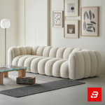 Sunlit modern minimalist living room interior showcasing a luxury ribbed sofa upholstered in textured off white bouclé fabric featuring distinct vertical channel tufting and continuous curved lines by Bahoo Furniture UAE