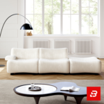 Bright sunlit modern minimalist living room interior showcasing a luxury ribbed lounge sofa upholstered in textured off white bouclé fabric featuring distinct vertical channel tufting and a sleek arch floor lamp by Bahoo Furniture UAE