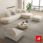 Bright modern minimalist living room interior showcasing an L-shaped modular sectional sofa upholstered in textured off white bouclé fabric featuring distinct half-moon backrests and accent pillows by Bahoo Furniture UAE