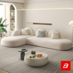 Bright modern minimalist living room interior showcasing an L-shaped modular sectional sofa upholstered in textured off white bouclé fabric featuring distinct half-moon backrests and accent pillows by Bahoo Furniture UAE