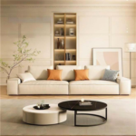 Modern minimalist living room interior showcasing a sleek contemporary sofa upholstered in rich beige leather fabric featuring wide armrests and stylish patterned throw pillows by Bahoo Furniture UAE