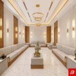 Symmetrical interior view of a luxury upholstered formal majlis seating sofa in off white velvet fabric featuring wooden paneling and marble coffee tables by Bahoo Furniture UAE