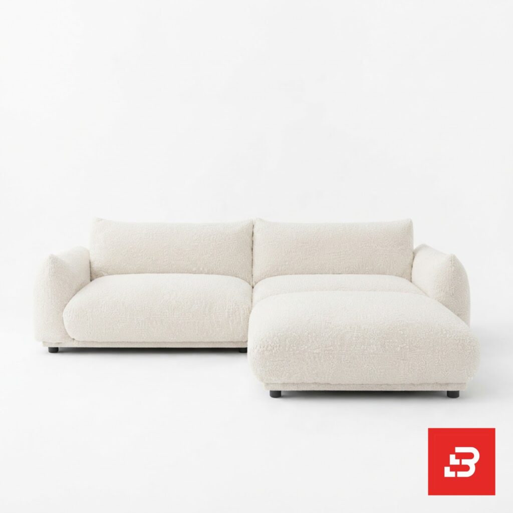 Clean studio product view of a luxury upholstered modular chaise sectional sofa in off white bouclé fabric featuring deep plush seating and a right-hand chaise extension by Bahoo Furniture UAE