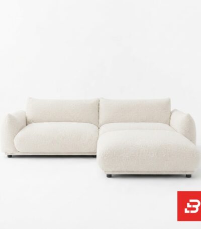 Clean studio product view of a luxury upholstered modular chaise sectional sofa in off white bouclé fabric featuring deep plush seating and a right-hand chaise extension by Bahoo Furniture UAE