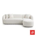 Studio product view of a luxury upholstered modern sectional sofa with chaise lounge in off white bouclé fabric featuring rounded armrests and accent throw pillows by Bahoo Furniture UAE