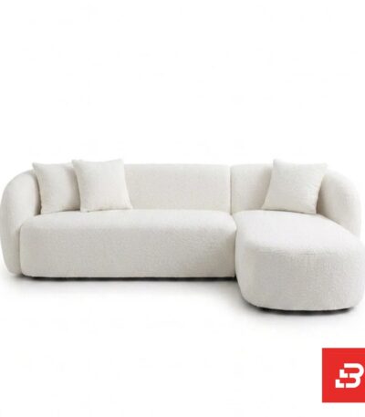 Studio product view of a luxury upholstered modern sectional sofa with chaise lounge in off white bouclé fabric featuring rounded armrests and accent throw pillows by Bahoo Furniture UAE