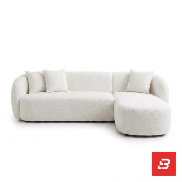 Studio product view of a luxury upholstered modern sectional sofa with chaise lounge in off white bouclé fabric featuring rounded armrests and accent throw pillows by Bahoo Furniture UAE