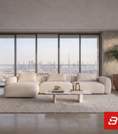 Elegant high-rise living room view of a luxury upholstered modern low-profile sectional sofa in off white bouclé fabric featuring a chaise lounge against a panoramic skyline window by Bahoo Furniture UAE