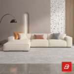 Modern living room interior view of a luxury upholstered chaise sectional sofa in smooth beige leather fabric with an extended chaise lounge and accent throw pillows by Bahoo Furniture UAE