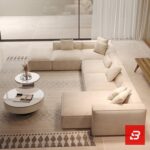 High-angle interior view of a luxury upholstered grand modular sectional sofa in beige velvet fabric featuring dual chaise extensions and accent pillows by Bahoo Furniture UAE