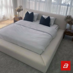 Contemporary tailored upholstered platform bed in soft ivory fabric by Bahoo Furniture UAE