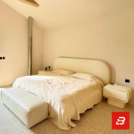 Arched minimalist upholstered platform bed in cream bouclé fabric by Bahoo Furniture UAE