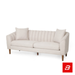 Sophisticated modern living room interior showcasing a luxury channel-tufted sofa upholstered in soft off white textured fabric featuring vertical back channeling and wooden tapered legs by Bahoo Furniture UAE