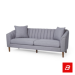 Sophisticated modern living room interior showcasing a luxury channel-tufted sofa upholstered in soft off white textured fabric featuring vertical back channeling and wooden tapered legs by Bahoo Furniture UAE