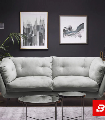 Sophisticated dark-walled modern living room interior showcasing a luxury tufted sofa upholstered in soft warm gray velvet fabric featuring button tufting and angled arms by Bahoo Furniture UAE