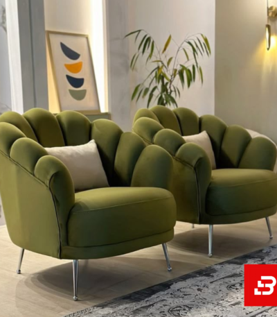 Elegant modern lounge setting showcasing plush scalloped shell-back accent armchairs with sleek metallic legs by Bahoo Furniture UAE