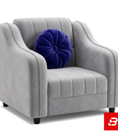 Modern studio setting featuring a luxury warm gray velvet channel-tufted armchair styled with a round royal blue accent cushion by Bahoo Furniture UAE