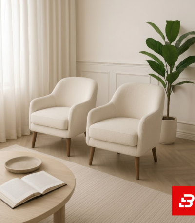 Sunlit modern lounge corner featuring a pair of off white bouclé accent armchairs on wooden legs beside a round coffee table by Bahoo Furniture UAE Craftsmanship Details Tactile Comfort: Wrapped in high-density, multi-tonal bouclé that adds rich texture and depth to neutral color schemes while holding up to daily lounging and heavy use. Supportive Geometry: Every tapered backrest and thick seat cushion is padded with high-resilience foam padding, removing sharp angles to create a secure, comfortable, and inviting environment for relaxed evenings. Low-Profile Proportions: Designed close to the floor with structured architectural silhouettes, encouraging an open, airy feeling while maintaining a commanding, sophisticated presence in the room. Open-Concept Fluidity: Engineered with clean organic curves and slender wooden legs, allowing you to establish a seamless focal point that perfectly fits upscale UAE interior spaces. Specifications Brand: Bahoo Furniture Model: The Luxury Bouclé Accent Armchair Fabric Grade: Luxury Commercial-Grade Bouclé (Off White - #FAF9F6) Internal Structure: Kiln-Dried Hardwood Frame with Reinforced Joinery Configuration Options: Single Seater Minimalist Accent Chair White-Glove Service: Custom Handcrafted in UAE | Complimentary In-Home Assembly Care & Preservation Routine Maintenance: Vacuum gently on low suction with a soft upholstery brush attachment. Spill Response: Blot immediately with a dry, clean microfiber cloth. Clean gentle spots using warm water and mild fabric shampoo; do not scrub forcefully.