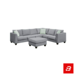 Bright and airy modern living room interior showcasing a large l-shape sectional sofa upholstered in soft warm gray fabric with pastel green throw pillows and a glass coffee table by Bahoo Furniture UAE