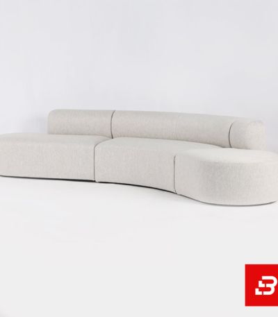 Minimalist studio setting showcasing a sleek organic curved sofa upholstered in soft off white bouclé fabric against a clean white background by Bahoo Furniture UAE