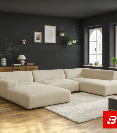 Sophisticated dark interior setting showcasing an expansive beige fabric u-shape sectional sofa against dark grey walls, framed art, and wooden flooring by Bahoo Furniture UAE