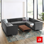 Spacious luxury living room featuring a warm gray velvet channel-tufted u-shape sectional sofa set with accent pillows and a wooden coffee table by Bahoo Furniture UAE