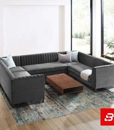 Spacious luxury living room featuring a warm gray velvet channel-tufted u-shape sectional sofa set with accent pillows and a wooden coffee table by Bahoo Furniture UAE