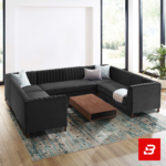 Spacious luxury living room featuring a warm gray velvet channel-tufted u-shape sectional sofa set with accent pillows and a wooden coffee table by Bahoo Furniture UAE