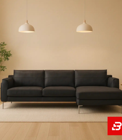 Warmly lit modern living room interior showcasing a warm gray leatherette l-shape sectional sofa with slim steel legs, minimalist pendant lamps, and indoor greenery by Bahoo Furniture UAE