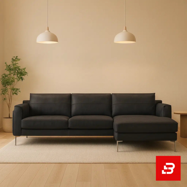 Warmly lit modern living room interior showcasing a warm gray leatherette l-shape sectional sofa with slim steel legs, minimalist pendant lamps, and indoor greenery by Bahoo Furniture UAE