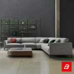 Overhead aerial interior view of a modern minimalist living room featuring a warm gray fabric u-shape sectional sofa styled with colorful accent pillows, a stone-top coffee table, and side accent tables by Bahoo Furniture UAE