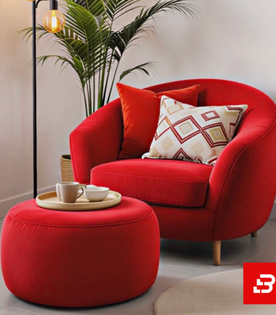 Modern cozy living room setup featuring a plush curved lounge armchair with a matching round ottoman stool and standing lamp by Bahoo Furniture UAE