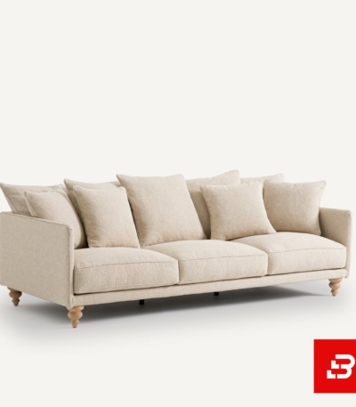 Studio product render of a modern luxury beige fabric 3-seater sofa with turned wooden feet and abundant scatter back cushions by Bahoo Furniture UAE