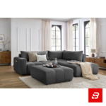 Bright modern living room interior featuring a warm gray fabric tufted l-shape sectional sofa with vertical channel tufting, matching footrest ottoman, and arched window by Bahoo Furniture UAE