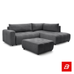 Bright modern living room interior featuring a warm gray fabric tufted l-shape sectional sofa with vertical channel tufting, matching footrest ottoman, and arched window by Bahoo Furniture UAE
