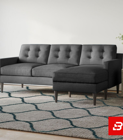 Modern minimalist living room featuring a tufted warm gray fabric l-shape sectional sofa with button details, wooden tapered legs, and a patterned rug by Bahoo Furniture UAE