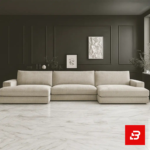 Sophisticated modern living room interior showcasing an expansive u-shape sectional sofa upholstered in rich beige textured fabric with dual chaise lounge ends against dark accent walls by Bahoo Furniture UAE
