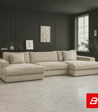 Sophisticated modern living room interior showcasing an expansive u-shape sectional sofa upholstered in rich beige textured fabric with dual chaise lounge ends against dark accent walls by Bahoo Furniture UAE