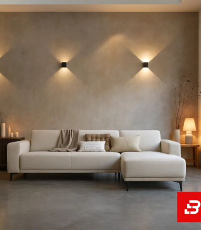 Warm and ambient modern living room interior showcasing a sleek l-shape sectional sofa upholstered in soft beige fabric paired with a matching chaise lounge against textured beige walls by Bahoo Furniture UAE