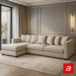 Elegant modern living room interior showcasing a sleek l-shape sectional sofa upholstered in soft beige fabric with multiple matching back cushions and a chaise lounge against paneled taupe walls by Bahoo Furniture UAE