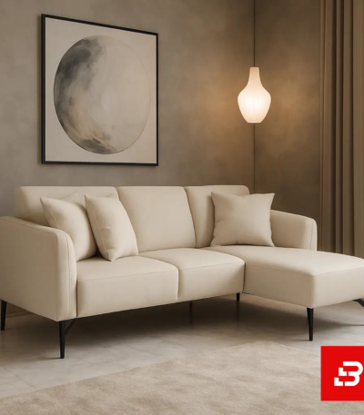 Cozy and minimalist modern living room interior showcasing a compact l-shape sectional sofa upholstered in soft off white fabric paired with a matching chaise lounge and abstract wall art by Bahoo Furniture UAE